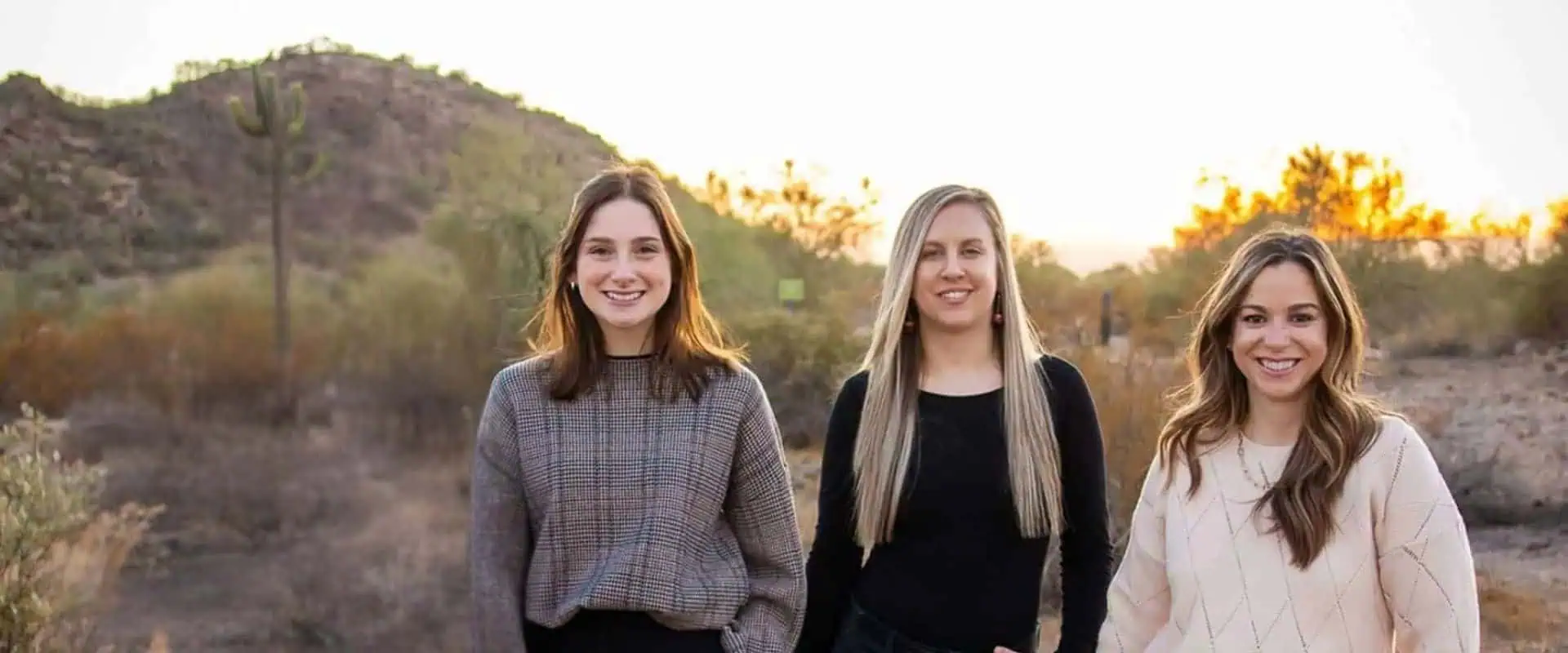 The Copper Wren Law team photographed in the Arizona desert at sunset